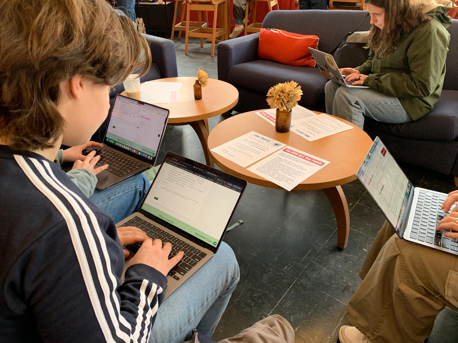 Students on laptops emailing their representatives during the SAVE Act phone banking event.